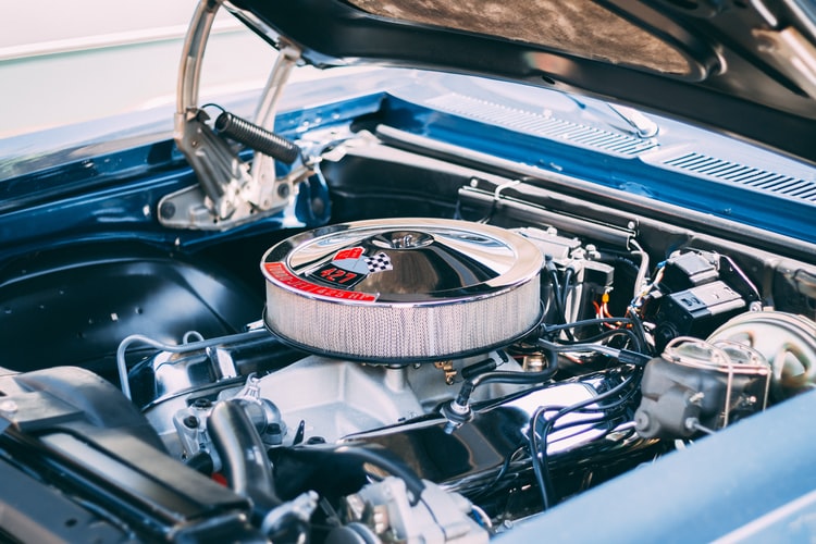 a lifted car hood revealing its shiny components including a powerful engine like the CMS of a website