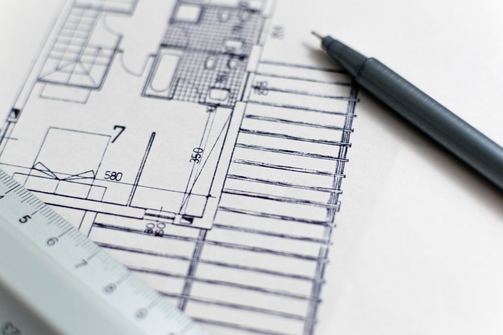 an architectural plan with ruler and pen