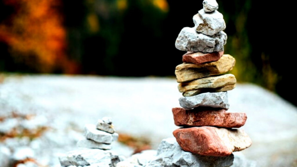 two pebble stacks kept side by side to represent success comparison